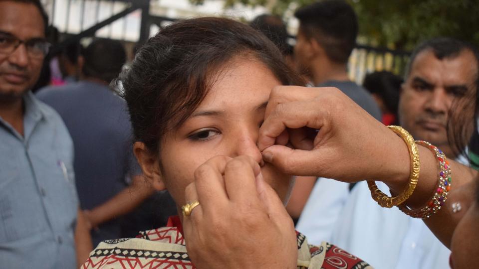 A parent removes the nose pin of a student at the Government Model Senior Secondary School exam centre in Sector 23, Chandigarh. (Sikander Singh Chopra/HT Photo)